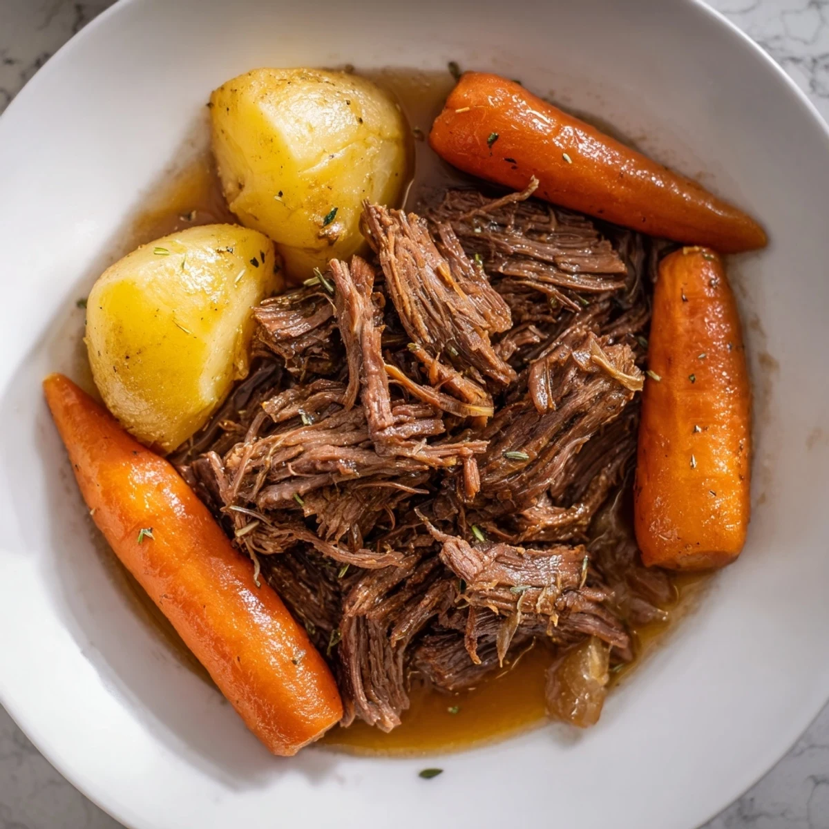Tender Slow Cooker Roast Beef with potatoes and carrots, slow-cooked in savory herbs.