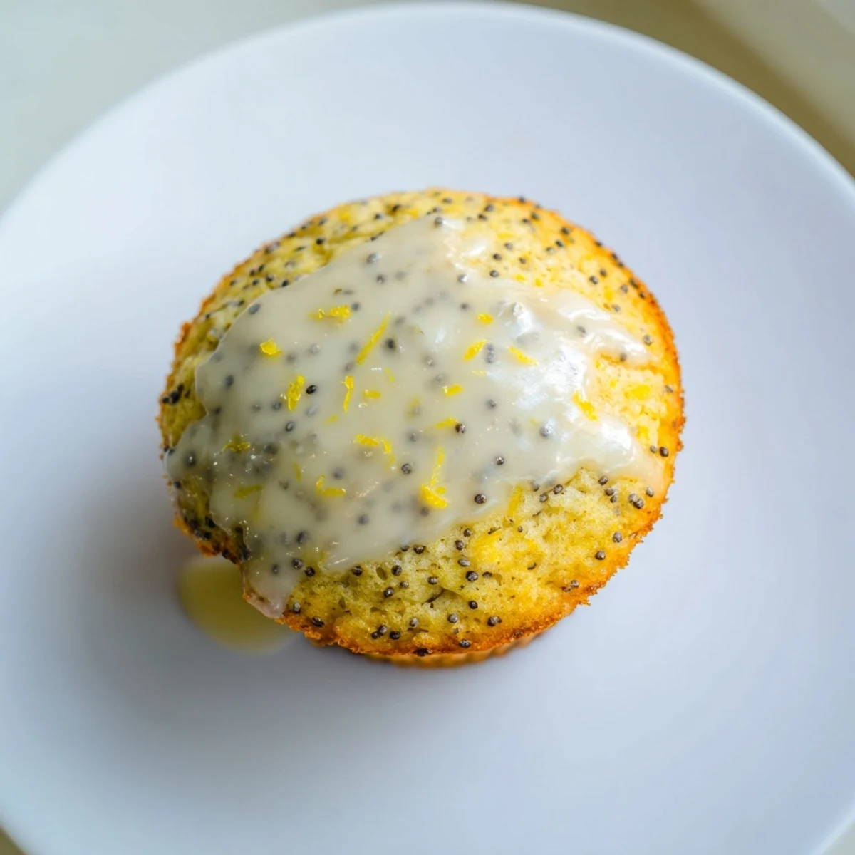 Overhead view of Lemon Poppy Seed Muffins with a sweet glaze, perfect for a snack with a cup of coffee.