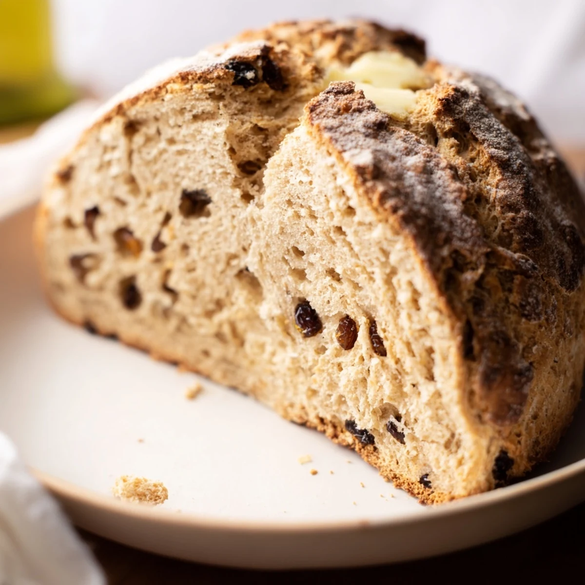 Freshly baked Irish Soda Bread with Caraway Seeds showing a golden crust and soft crumb on a rustic cutting board.