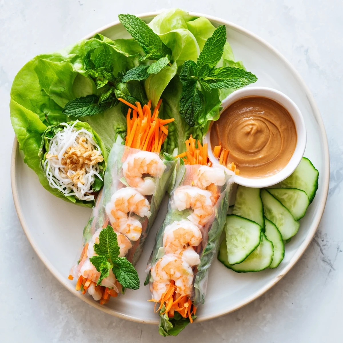 Close-up of vibrant Vietnamese Spring Rolls filled with vermicelli noodles and herbs, ready to be dipped in savory peanut sauce.  