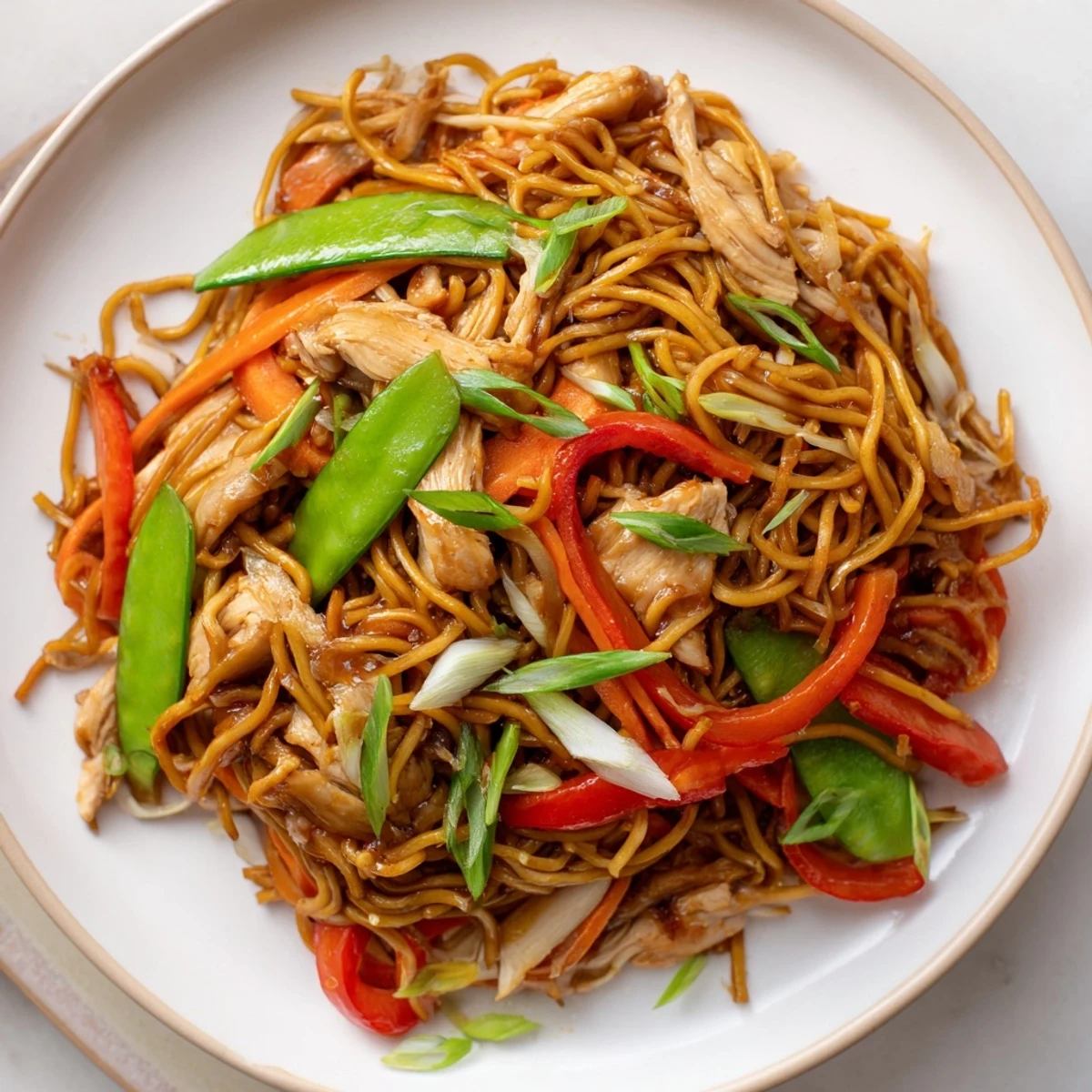 Steaming bowl of homemade Chicken Chow Mein loaded with tender chicken, crisp bean sprouts, and savory stir-fry sauce.