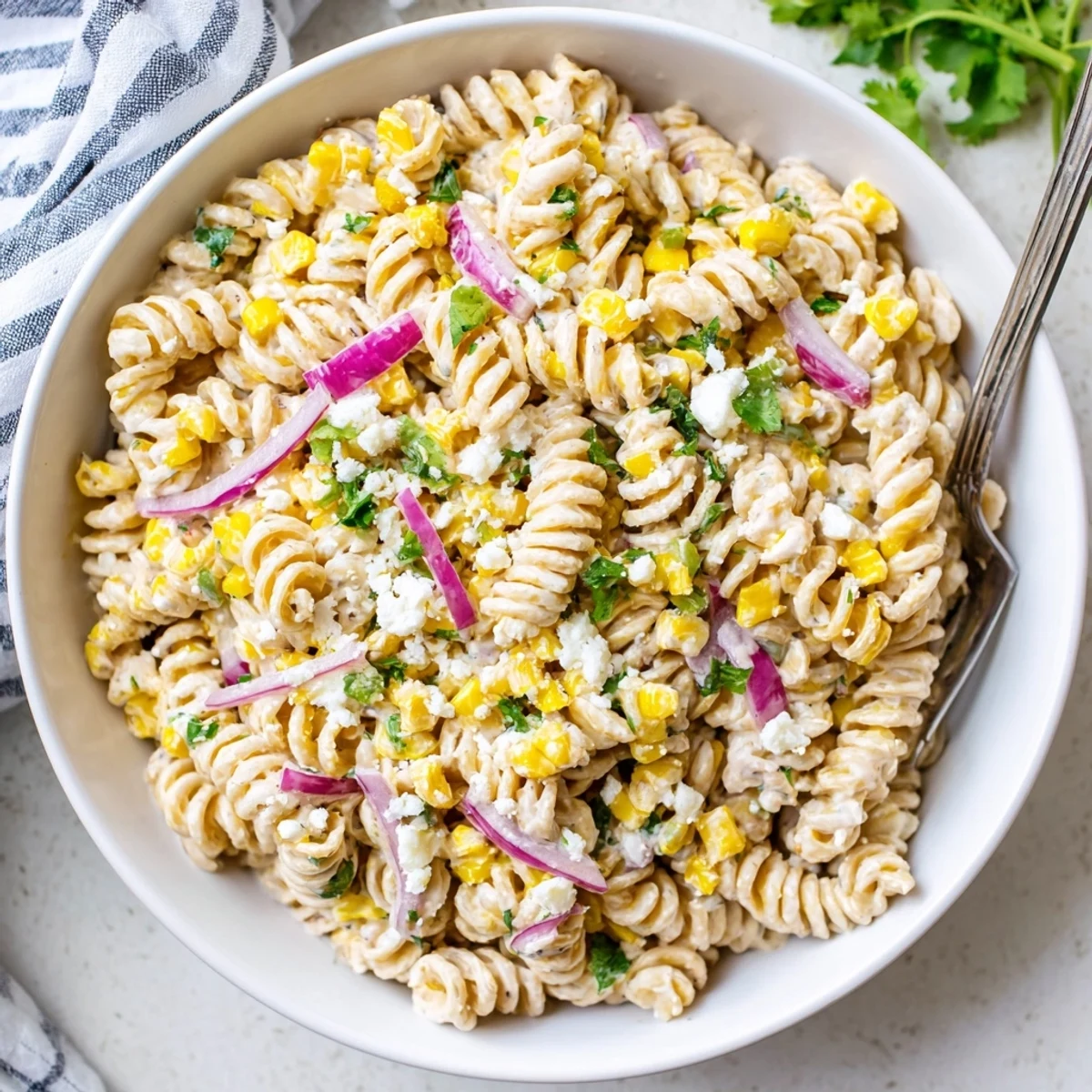Vibrant Mexican Street Corn Pasta Salad tossed in creamy spicy dressing with fresh cilantro