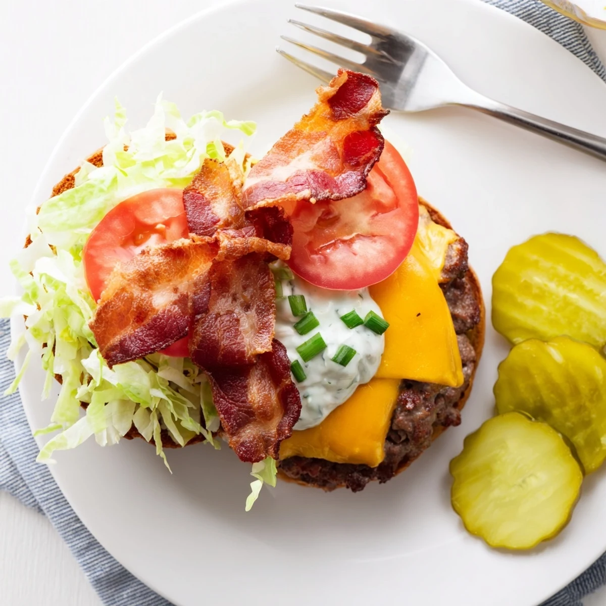 Golden crack burgers topped with sharp cheddar cheese, crunchy bacon, and fresh lettuce for the ultimate cookout feast
