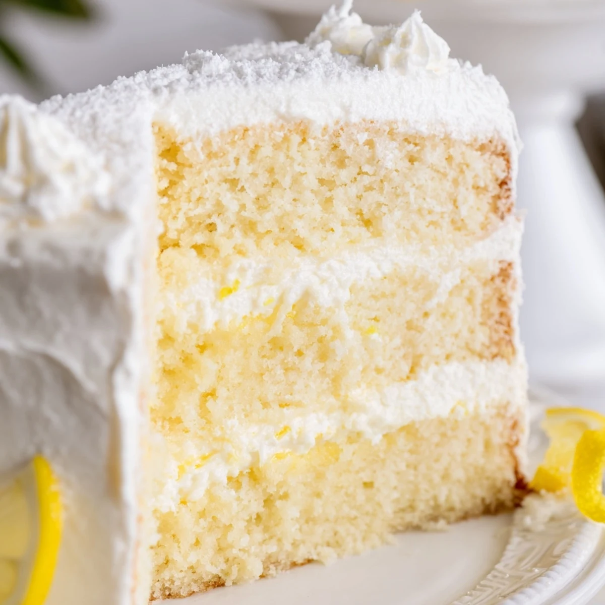 Elegant Italian lemon cream cake with creamy mascarpone layers and fresh lemon garnish on white plate