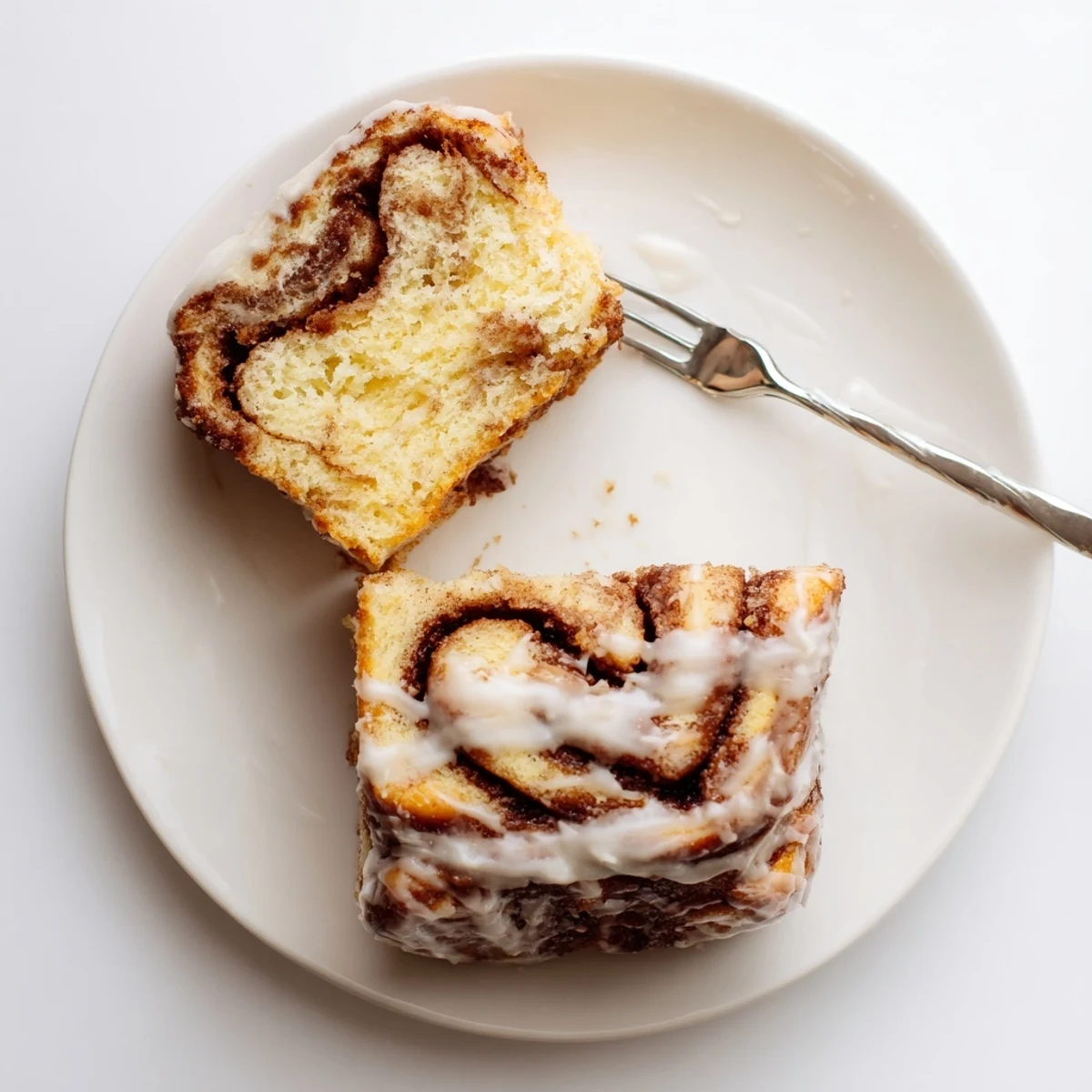 Soft buttery breakfast cake marbled with cinnamon sugar layers and topped with sweet icing