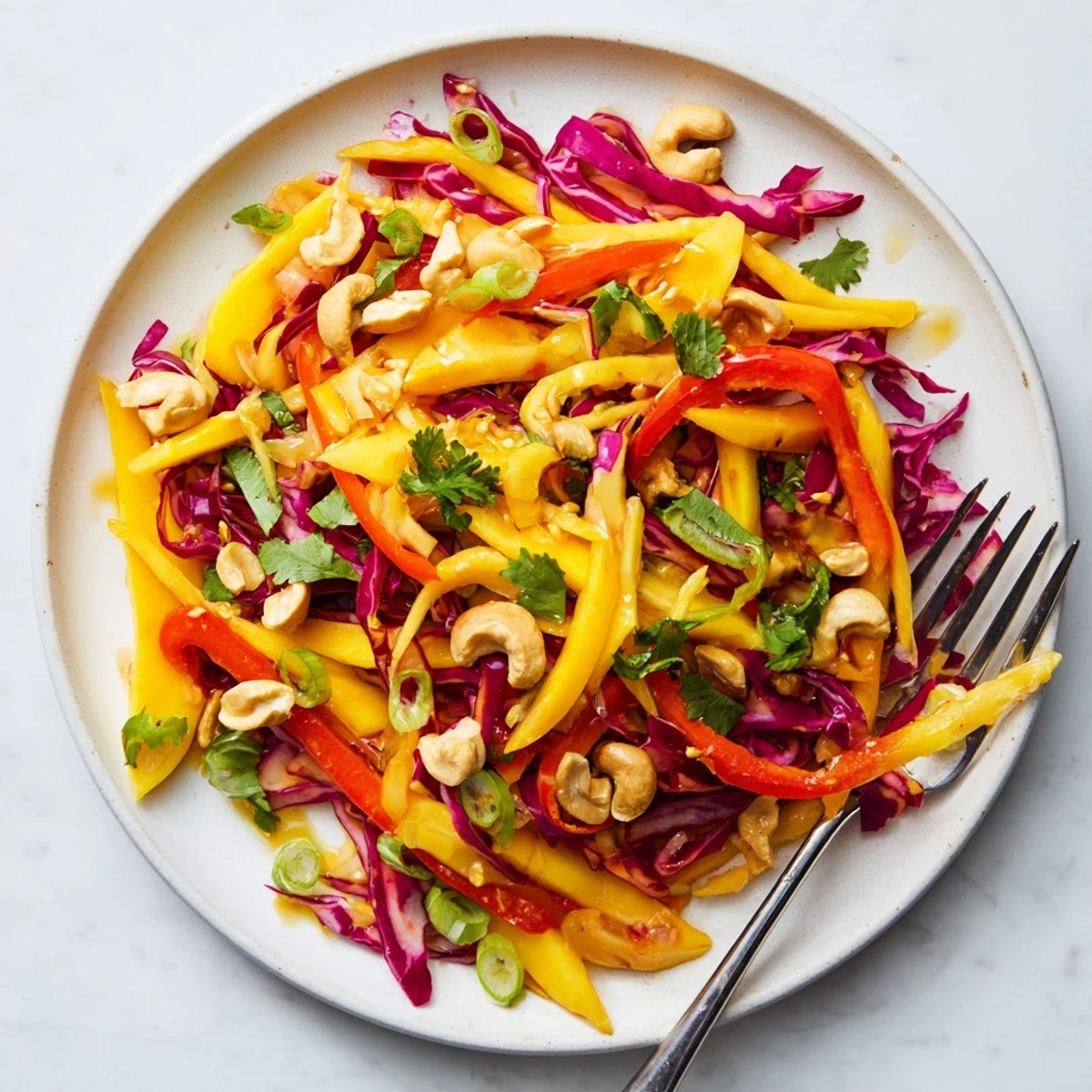 Fresh mango slaw with crisp red cabbage and colorful vegetables in lime dressing