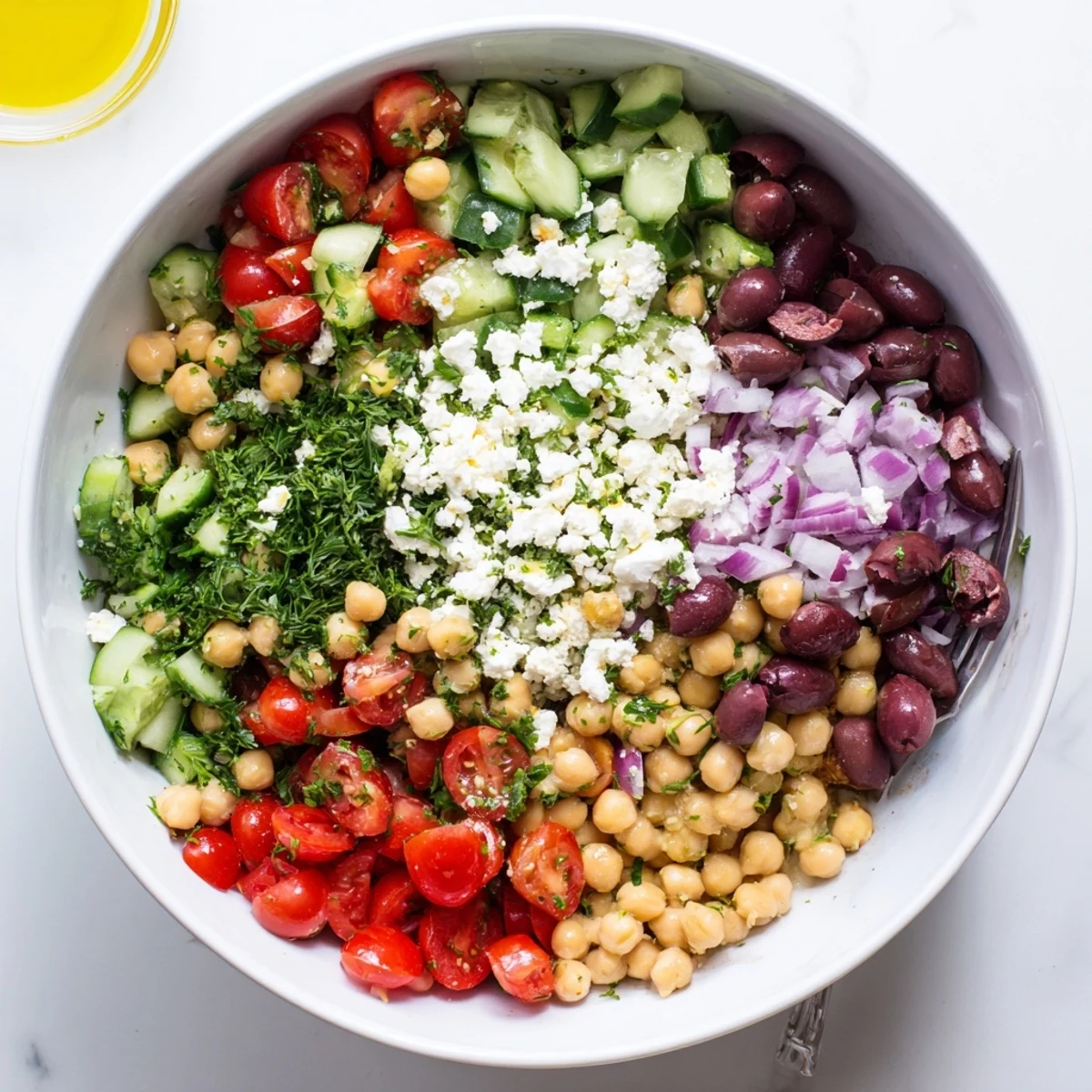 Light and refreshing Mediterranean chickpea salad served with feta cheese, parsley, and vibrant vegetables