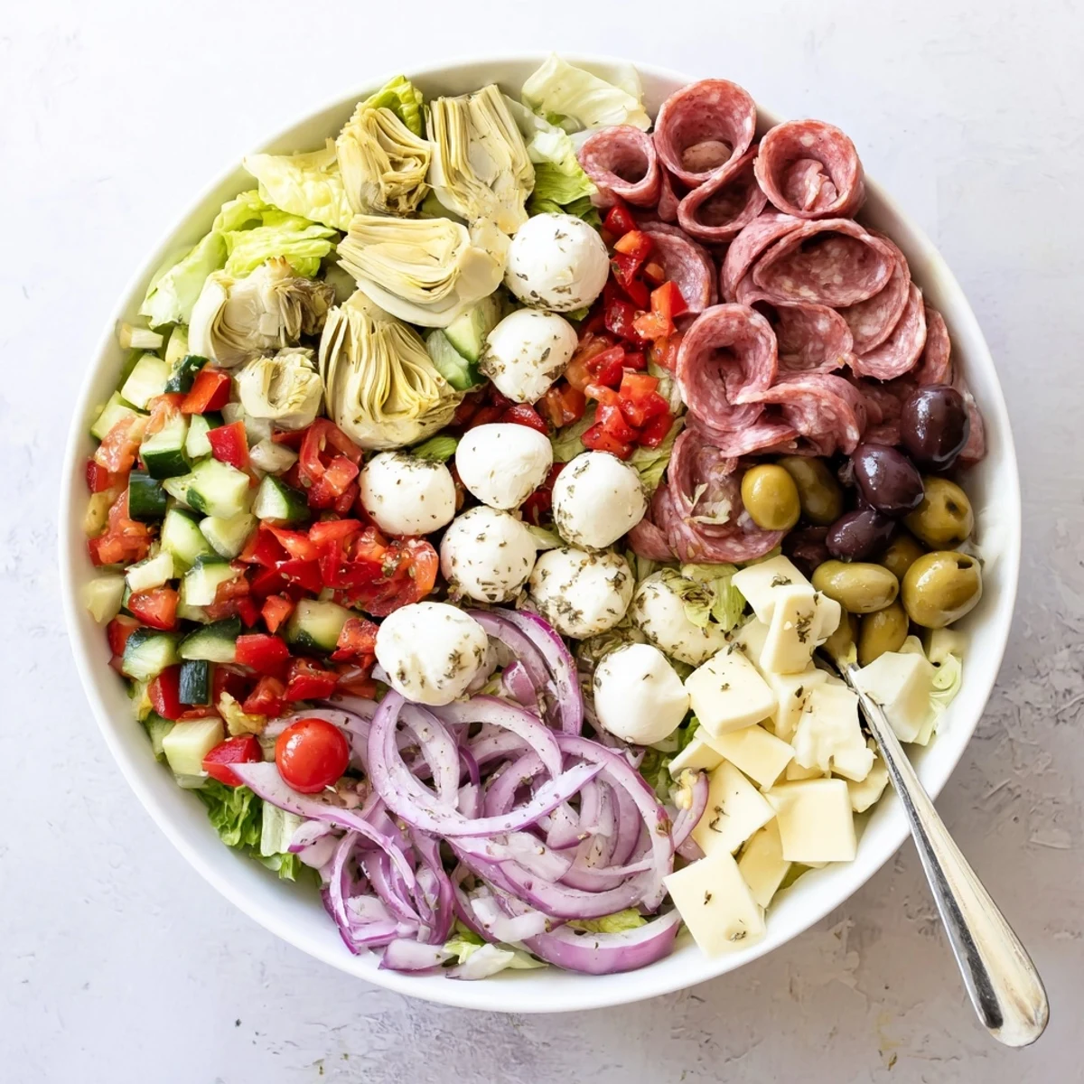 Hearty antipasti chopped salad tossed with red wine vinegar dressing and topped with cured meats