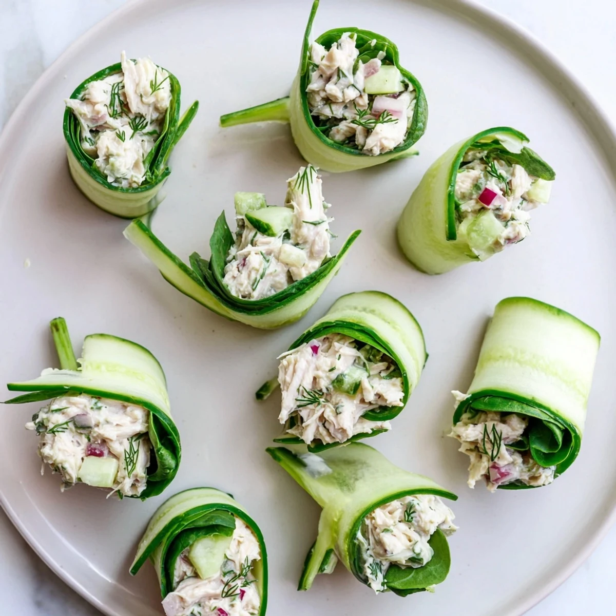 Low carb chicken salad cucumber roll ups with dill and fresh herbs