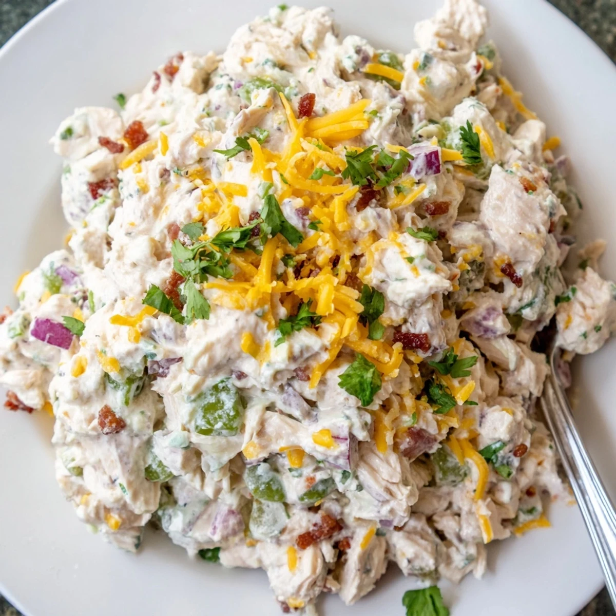Keto-friendly jalapeno popper chicken salad served in lettuce cups with fresh cilantro garnish