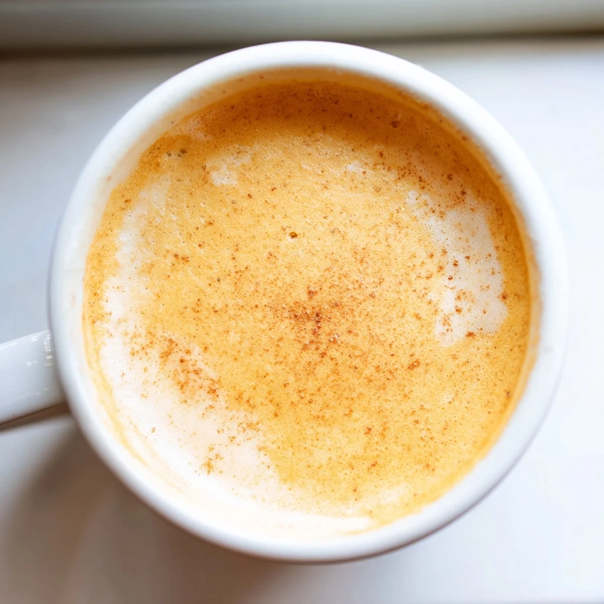 Velvety Goguma Latte with a swirl of golden sweet potato and steamed milk