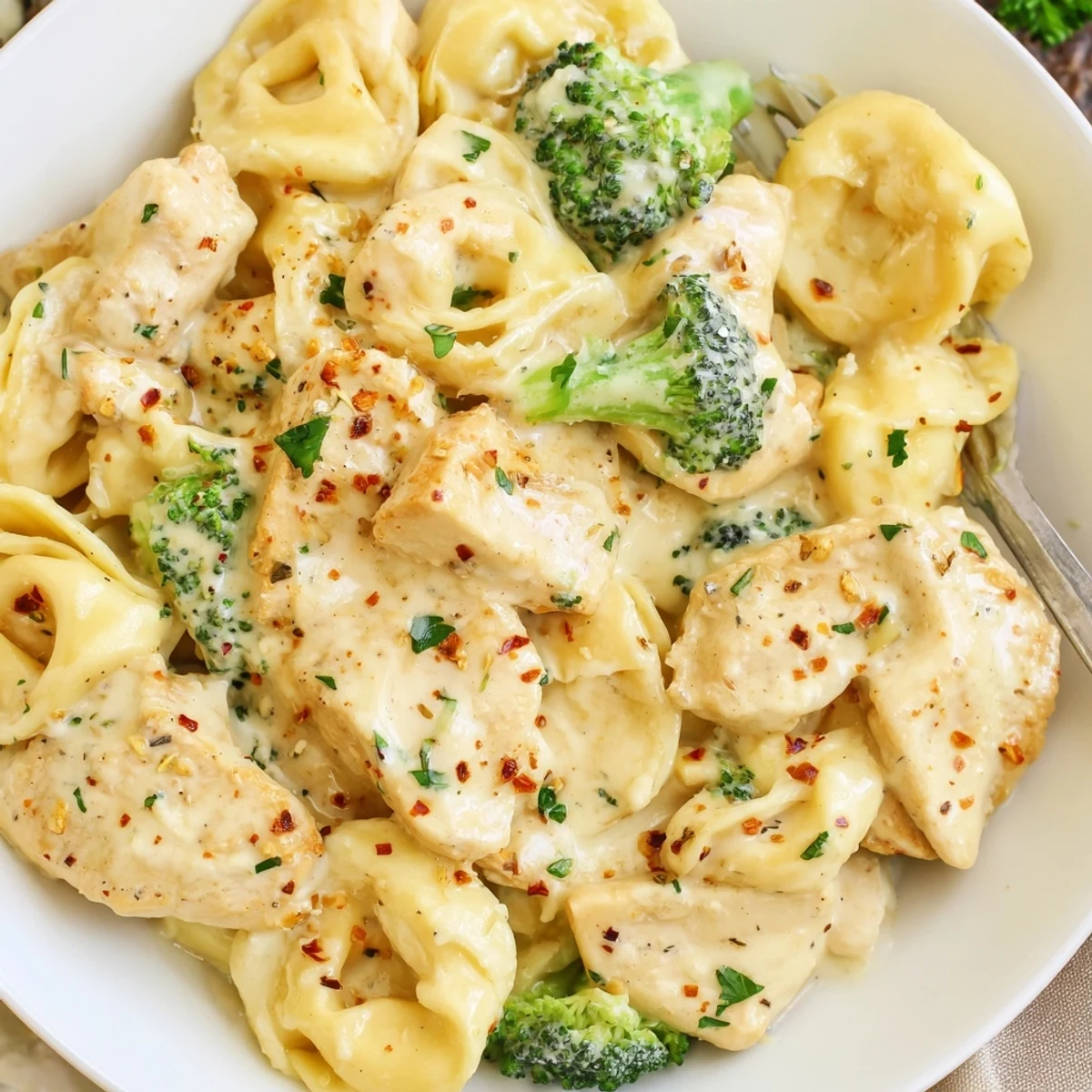 A bowl of Creamy Garlic Parmesan Tortellini Chicken Broccoli Recipe, tender bites