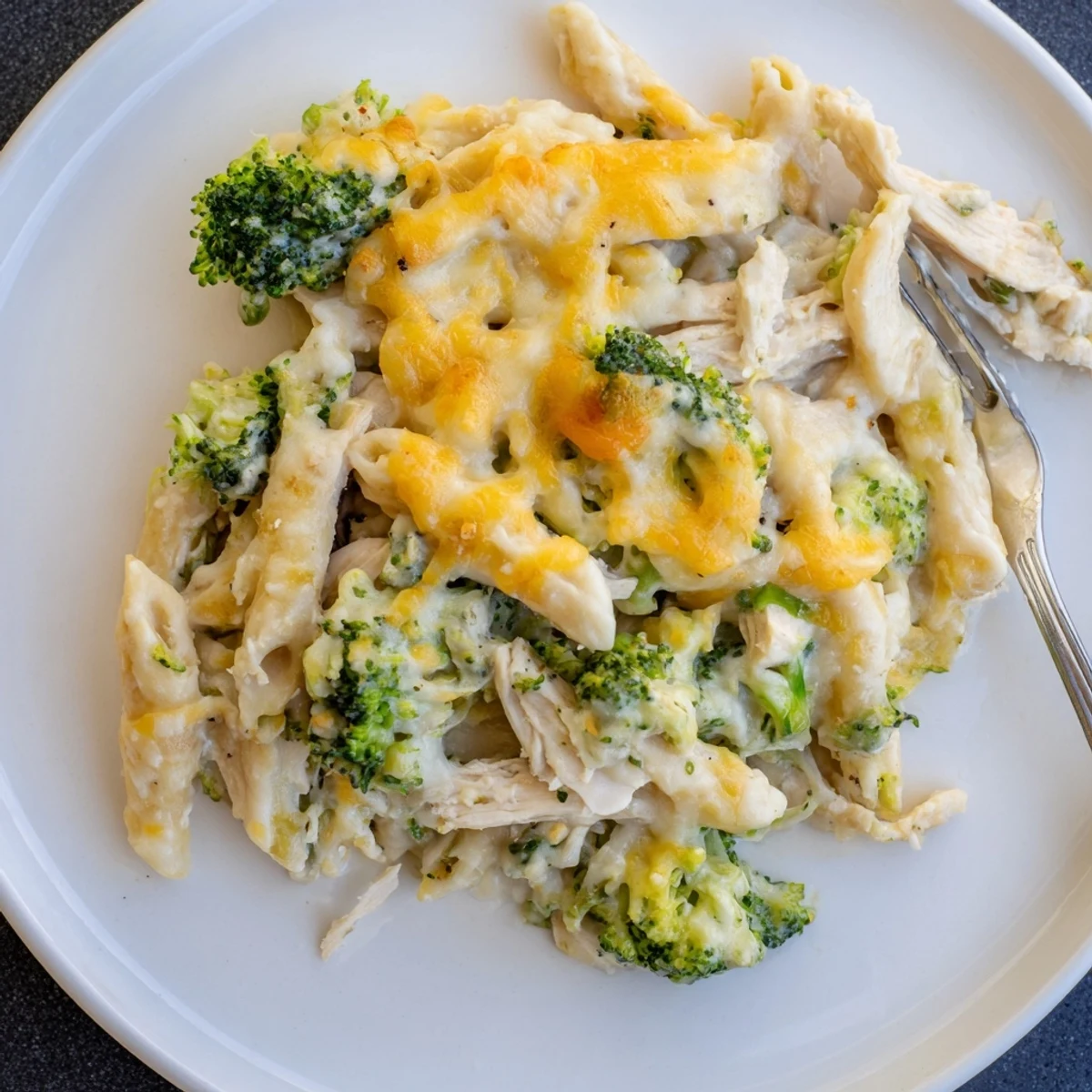 Creamy Chicken Broccoli Alfredo Bake served with garlic bread and parsley garnish
