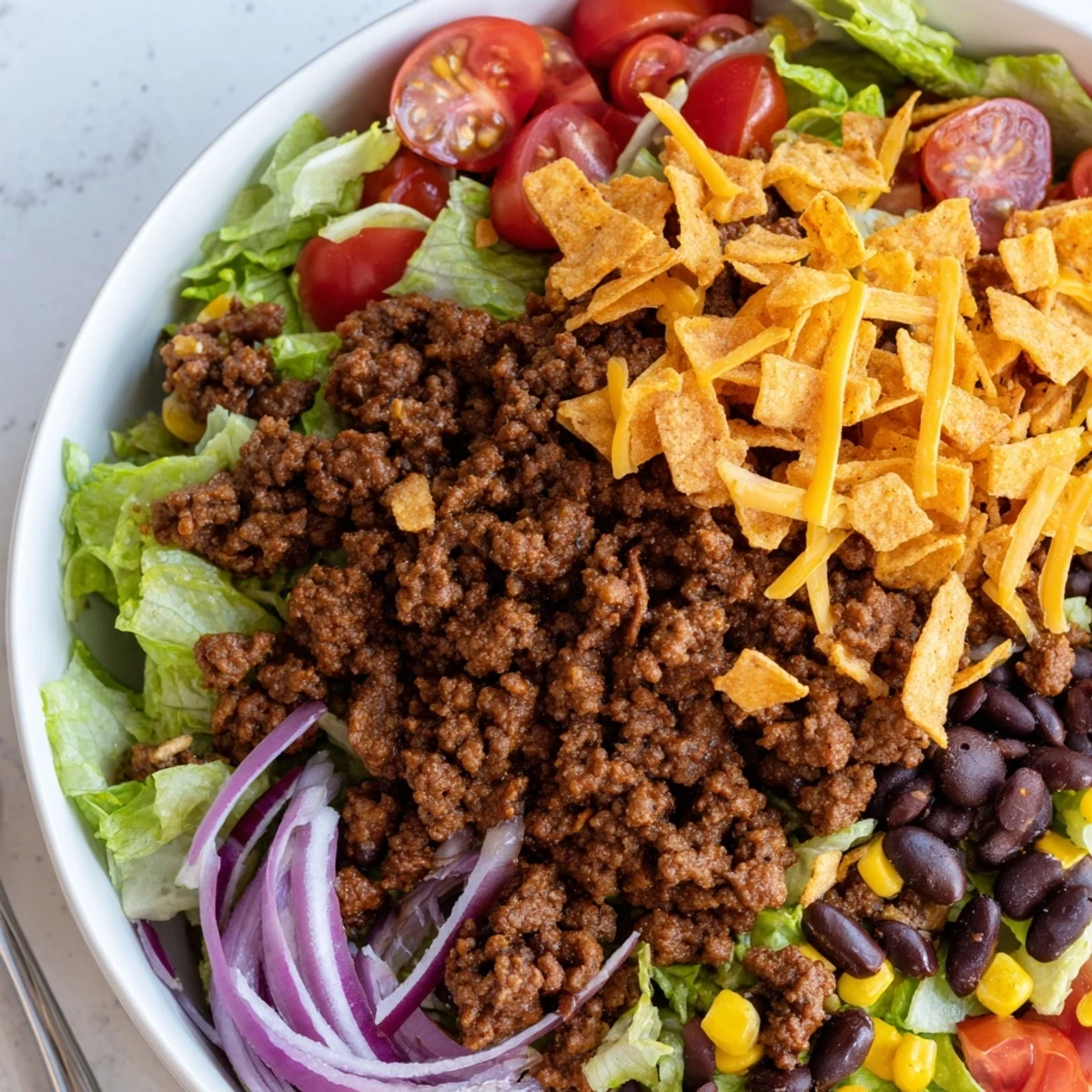 Warm seasoned beef crowns Simple Doritos Taco Salad, tossed with creamy ranch  