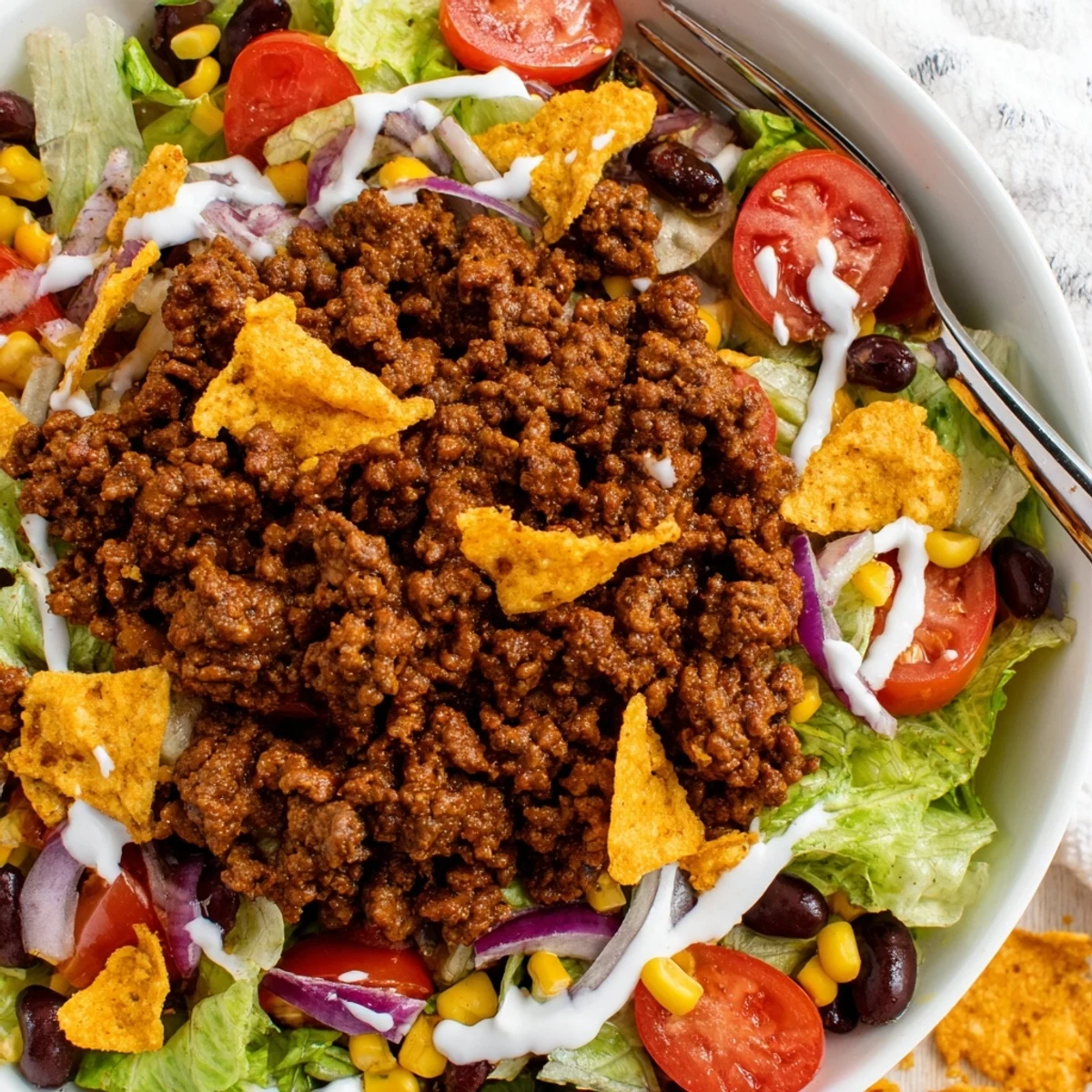 Serve Simple Doritos Taco Salad immediately to savor crisp chips and cheddar