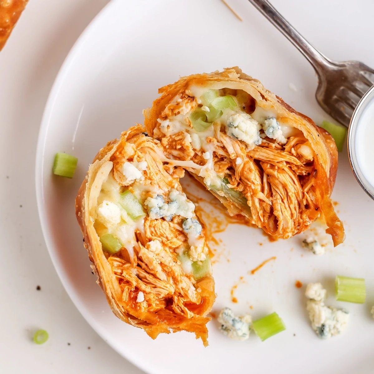 Crispy golden Buffalo Chicken Egg Rolls filled with spicy, melty mozzarella cheese