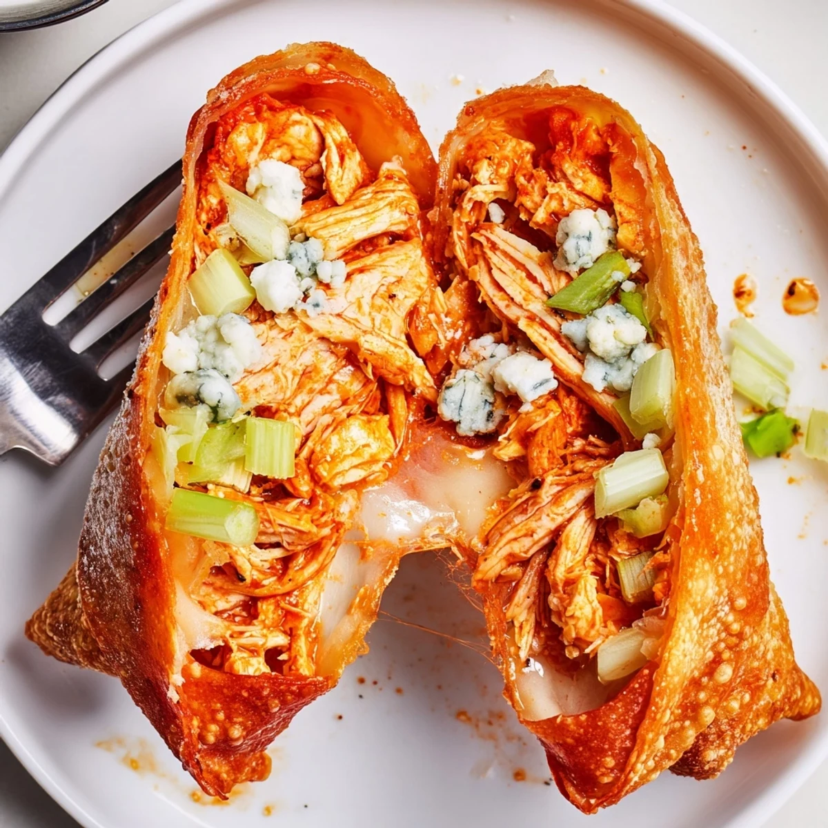 Freshly fried Buffalo Chicken Egg Rolls served hot with creamy blue cheese dip