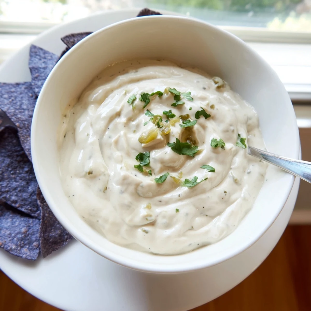 Thick white Mexican sauce drizzled generously over grilled chicken and warm corn tortillas