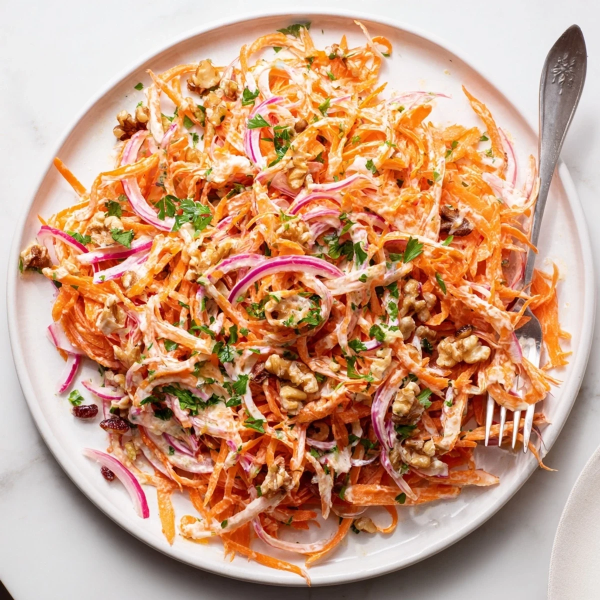 Crisp shredded apple carrot slaw topped with fresh parsley and creamy dressing