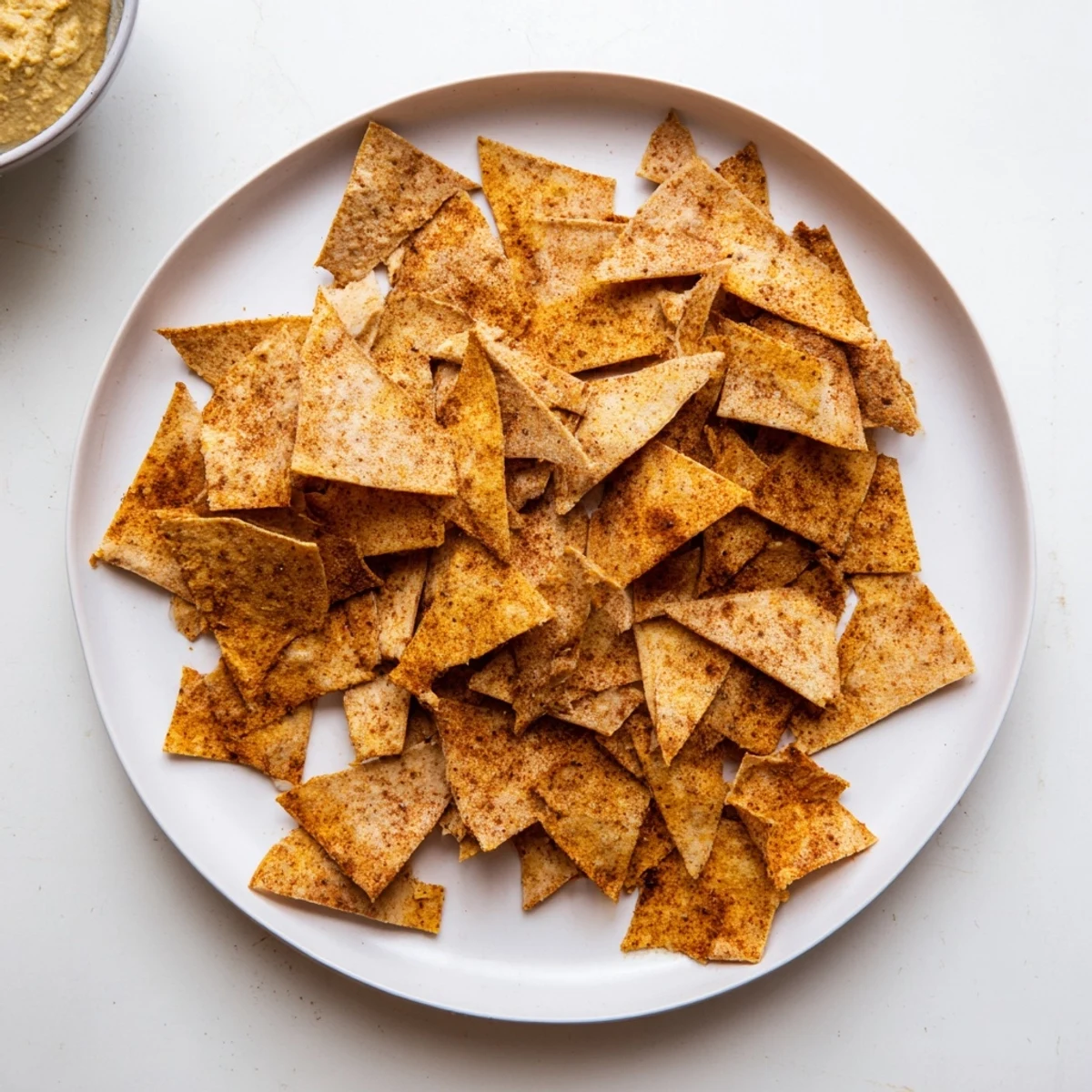 Golden brown crispy chickpea chips arranged on a wooden board ready for snacking