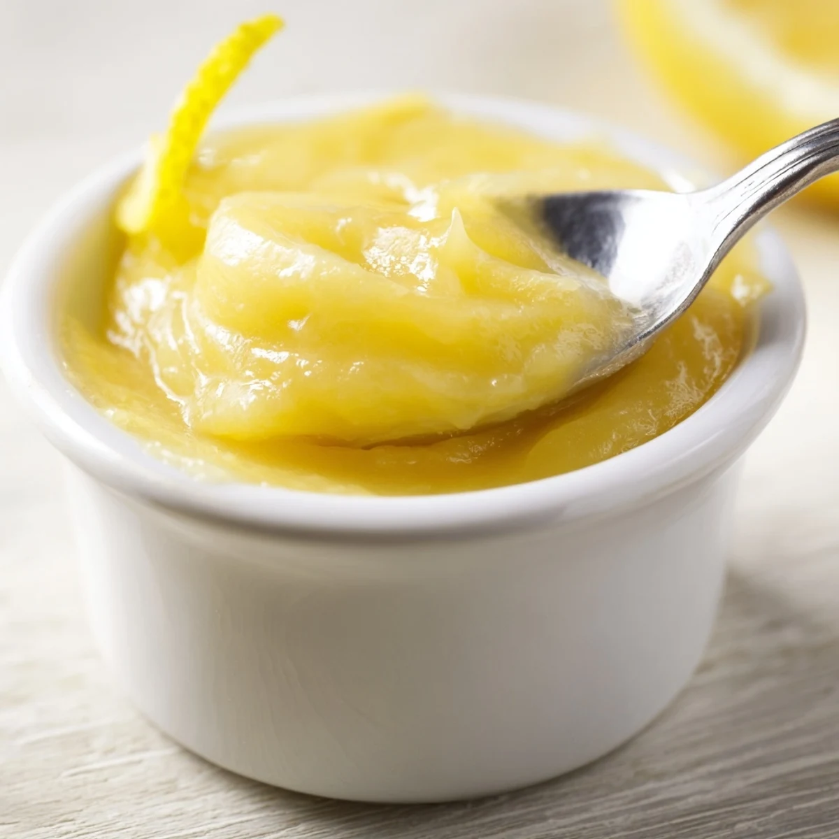 Homemade Lemon Curd glossy jar beside warm scones, bright citrus aroma.