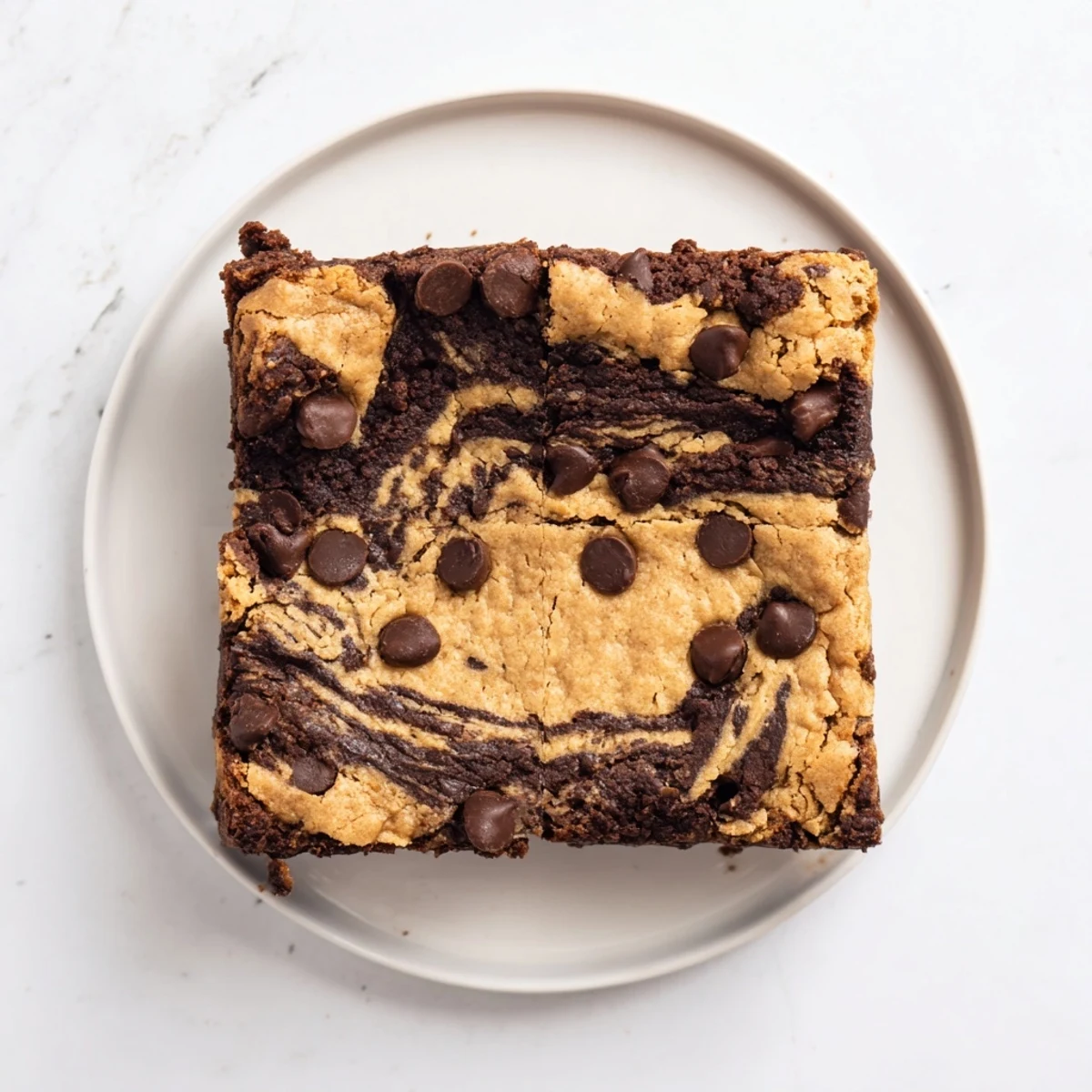Golden fudgy chewy brookies cooling in pan featuring swirled brownie and cookie dough