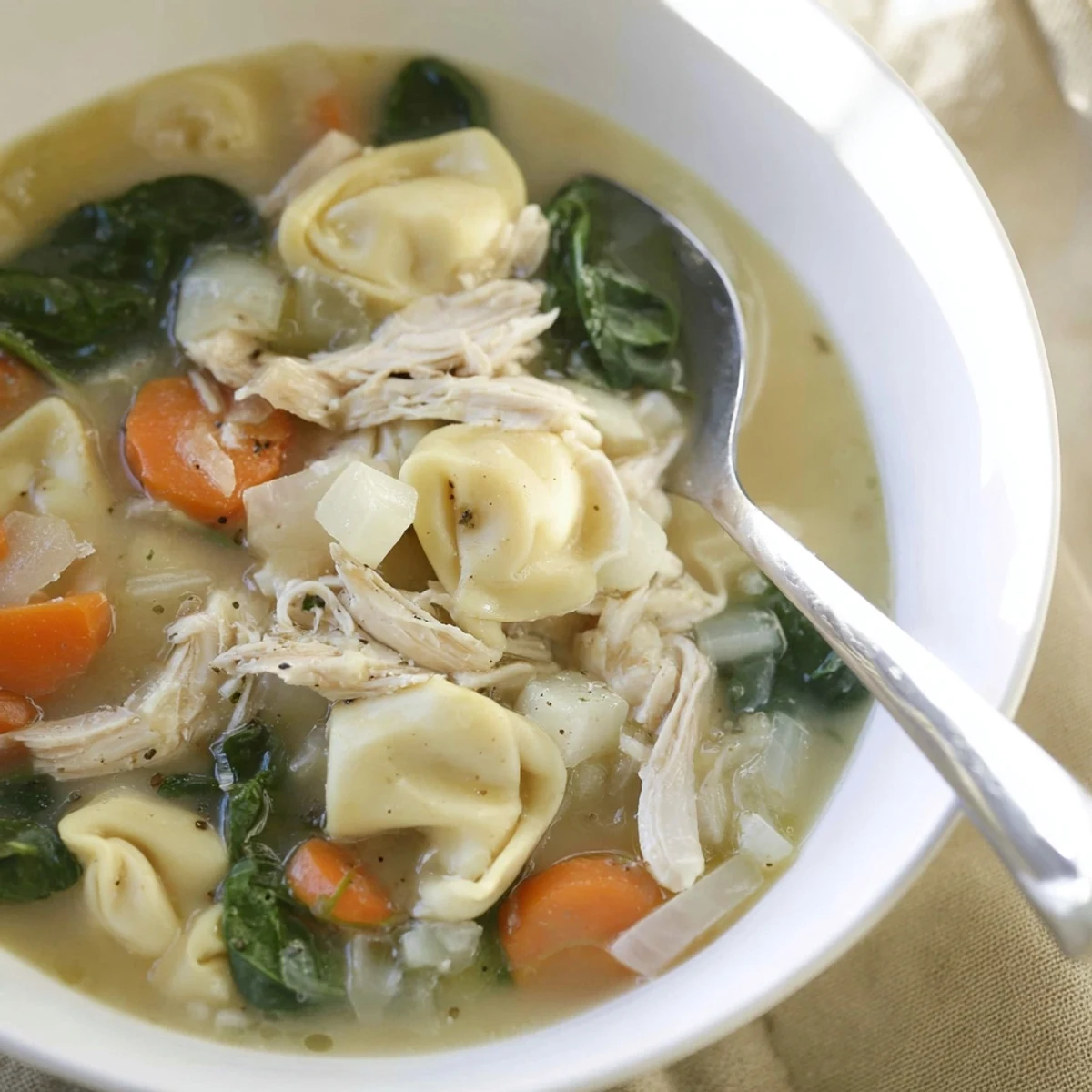 Savory Crockpot Chicken Tortellini simmered slowly with carrots and cheese-filled pasta.
