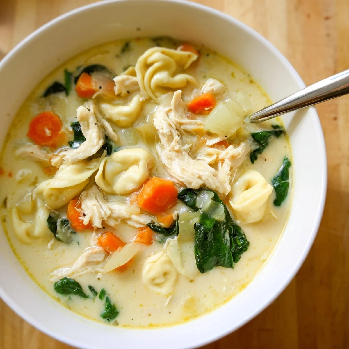 Hearty Crockpot Chicken Tortellini featuring tender shredded chicken in a rich broth.