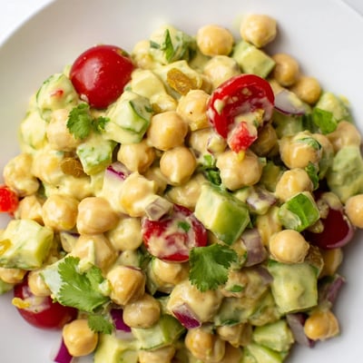 Fresh Curried Chickpea Salad in a white bowl, perfect for a light lunch or healthy meal prep.