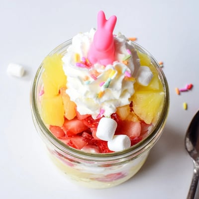 Cheerful Jello Pie Easter Bunny Parfait In A Jar features strawberry and lemon gelatin cubes in a clear glass.