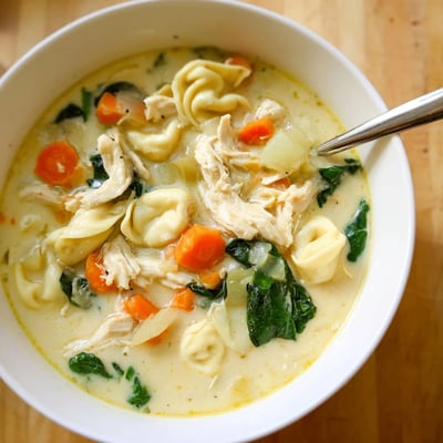 Hearty Crockpot Chicken Tortellini featuring tender shredded chicken in a rich broth.
